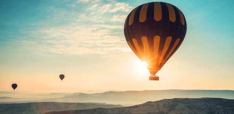 Hot air balloons flying over the valley at Cappadocia