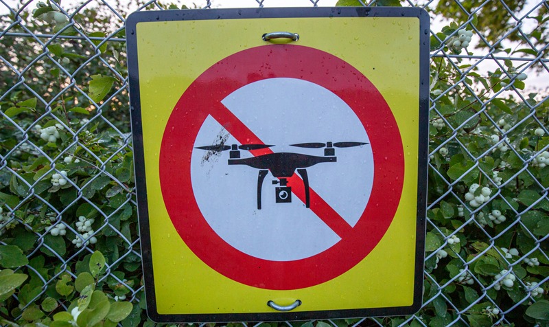 No Drone Warning Sign at Fence