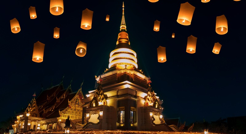 People walk with lighted candles to respect Buddha at thailand