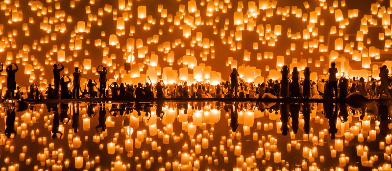 Thai people release sky floating lanterns or lamp to worship Buddha,s relics with reflection. Traditional festival in Chiang mai, Thailand