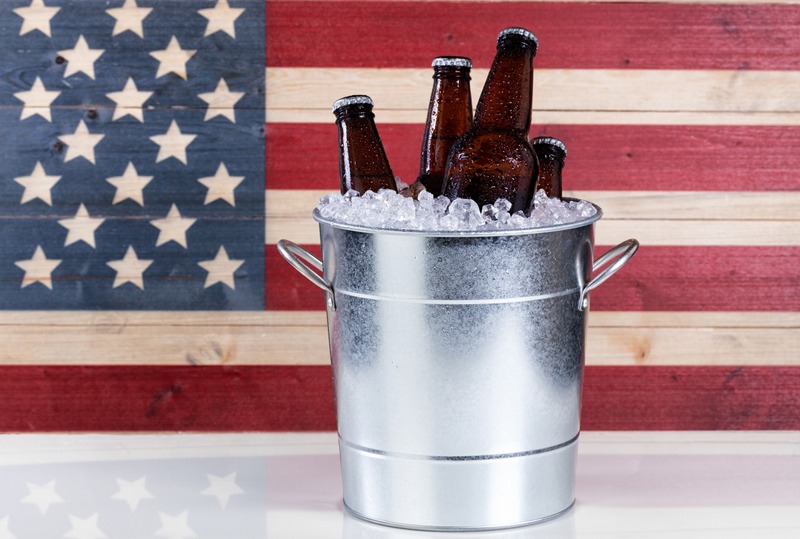 Bucket of ice cold beer with USA flag in background