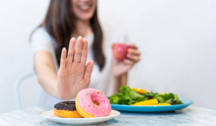woman refusing-sugary-foods