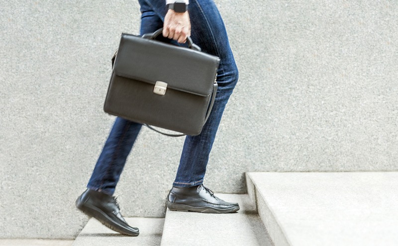A man holding a business suitcase