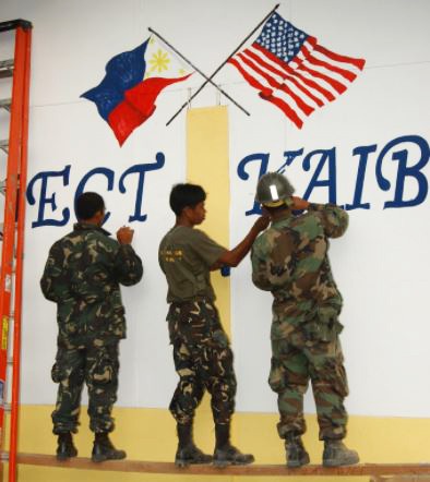 An image of Soldiers painting two flags