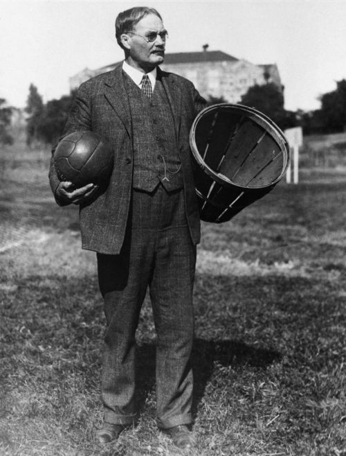Dr James Naismith holding a soccer ball and a peach basket