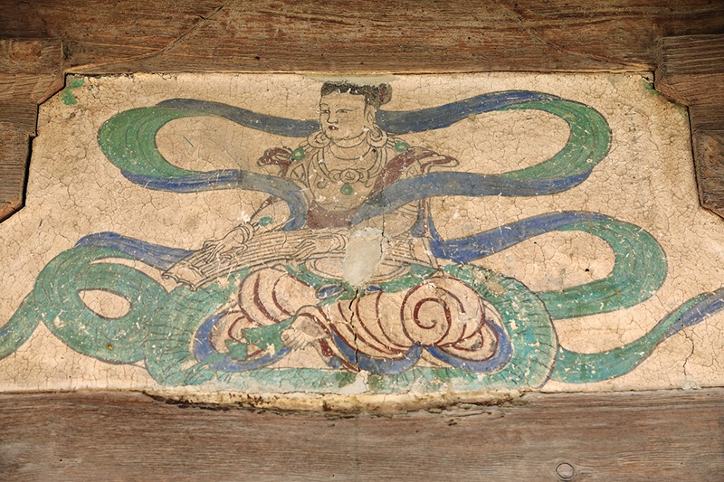 Fresco from the North Song dynasty of a musical Apsara-outer cliff wall of the Mogao caves hewn into the local sandstone showing Buddhist imagery from the 4th to the 14th century