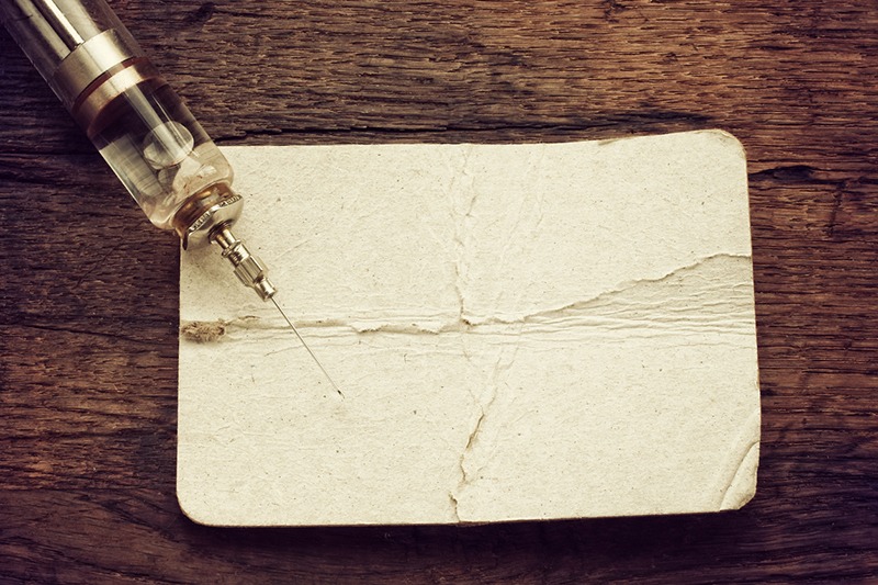 Image of a paper and syringe.