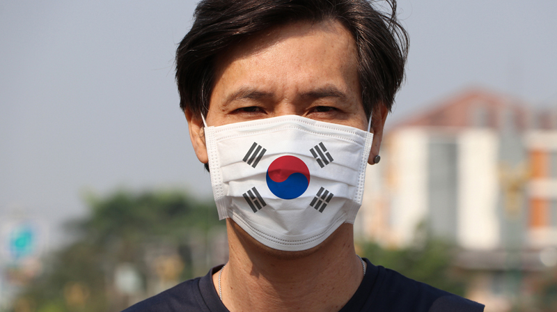 South Korean man wearing a mask with a South Korean flag design