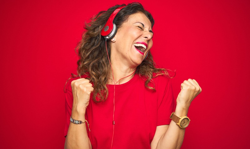 Woman listening music through a headphone