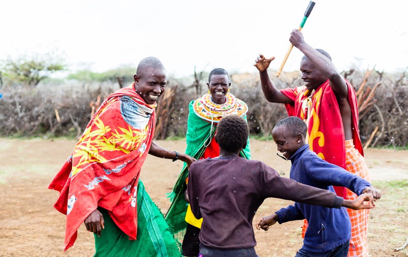 a Maasai family celebrating and dancing