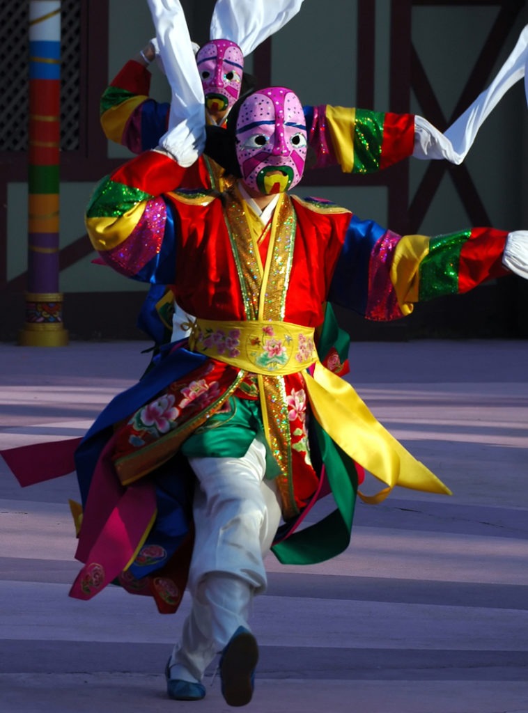 a dancer in a costume dancing the traditional Lunar New Year's dance in South Korea