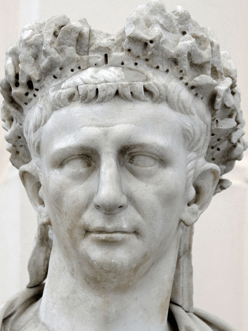a white statute, a head of Claudius