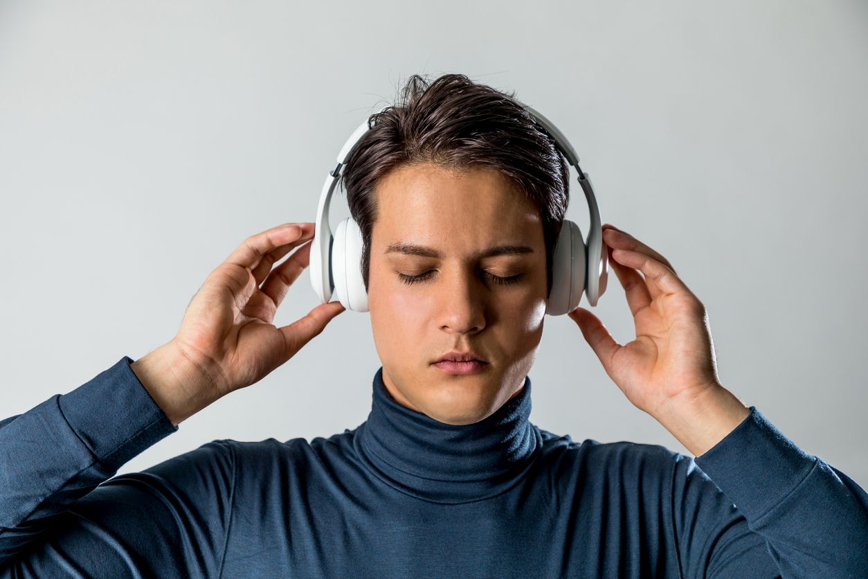 man using noise-canceling headphones