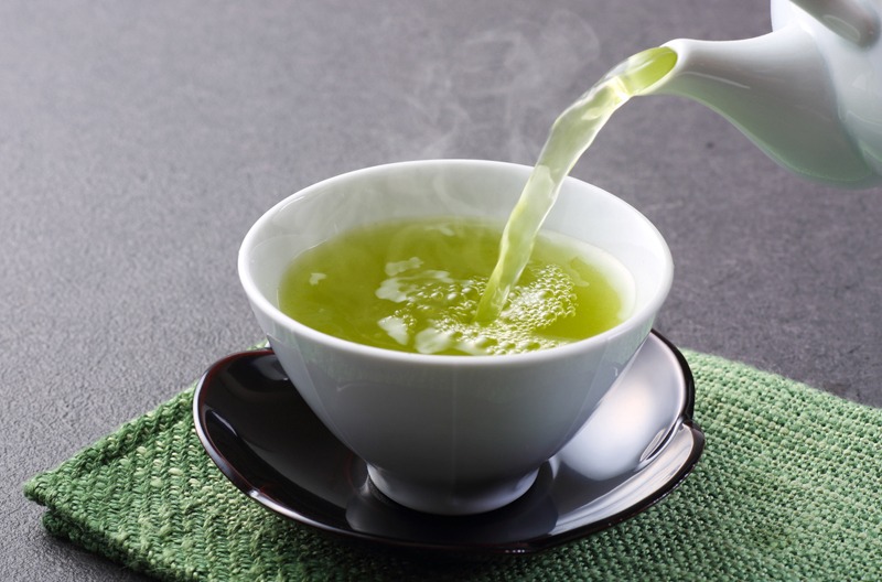 pouring green tea in a cup