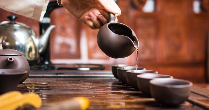 pouring traditional Chinese tea in cups