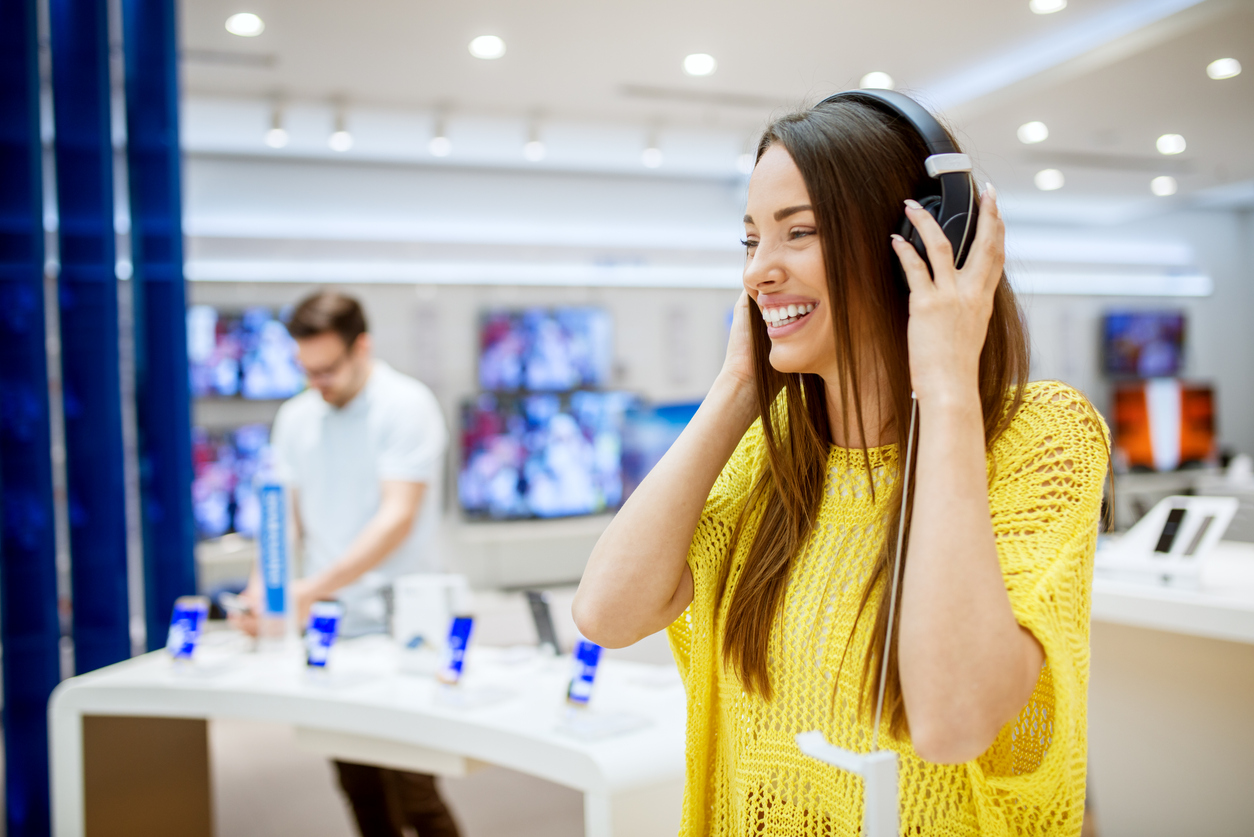 woman testing headphones in a store