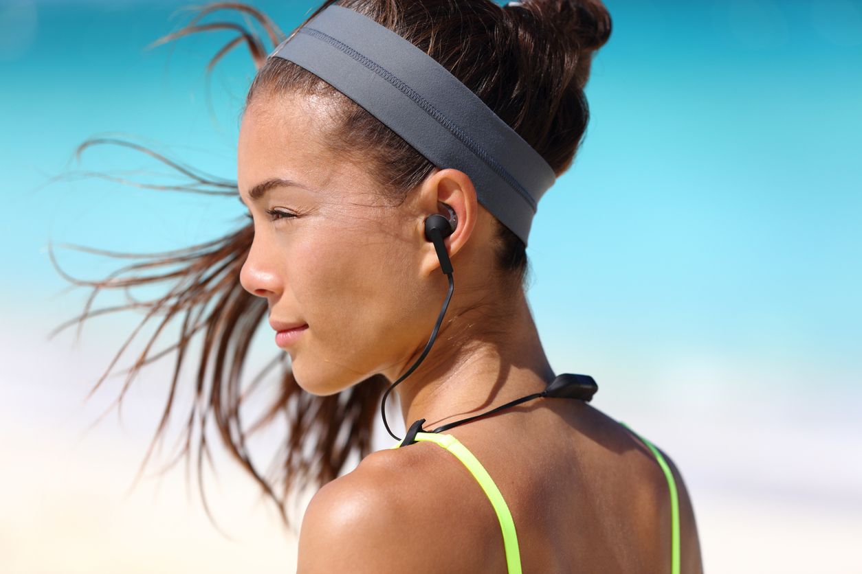 woman wearing wireless in-ear headphones
