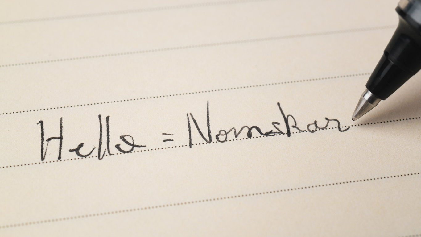 Beginner Bengali Bangla language learner writing Hello word Nomskar for homework