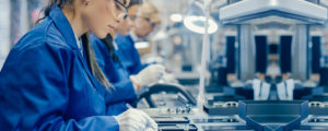 Female Electronics Factory Workers in Blue Work