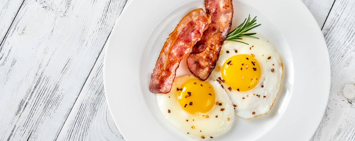 a plate of bacon and eggs