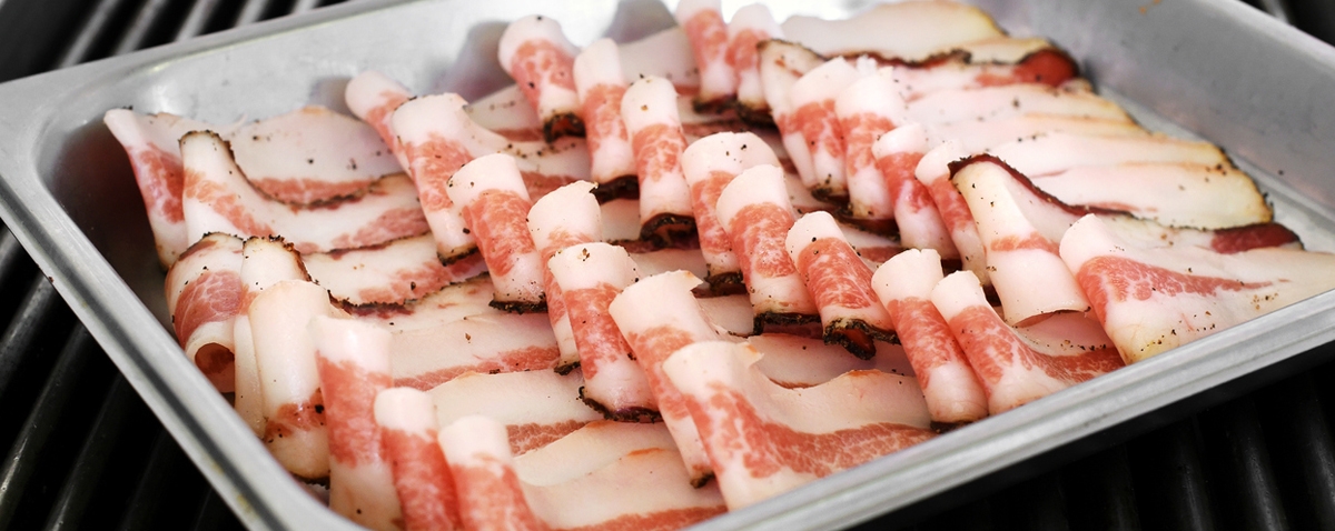 slices of pre-cooked bacon in a tray