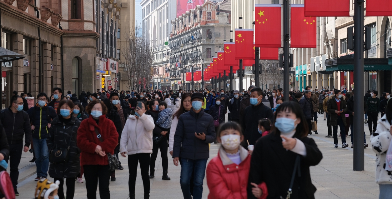 Crowded tourists in face mask, walking on Nanjing Road in Shanghai