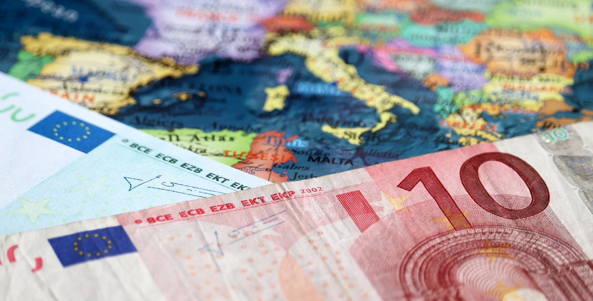 Euro banknotes on the map of Europe, selective focus