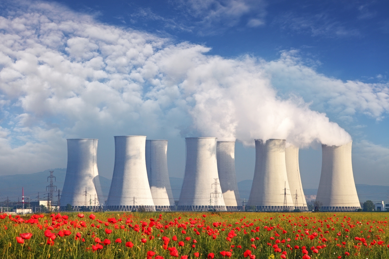 Nuclear Power plant with red field and blue sky