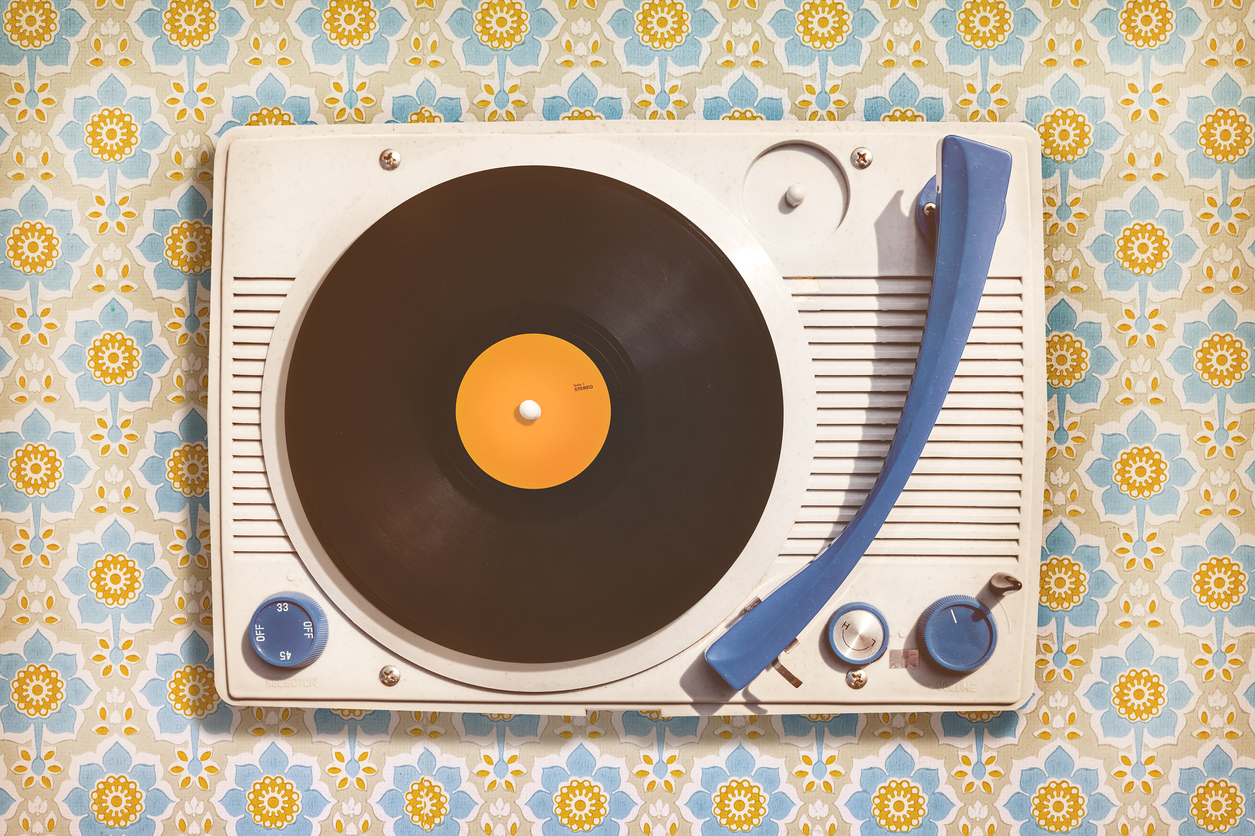 a vintage record player with floral background