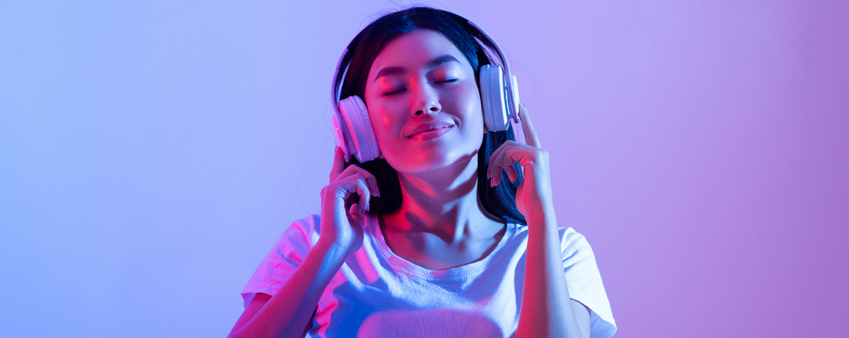 a woman with headphones on and listening to music