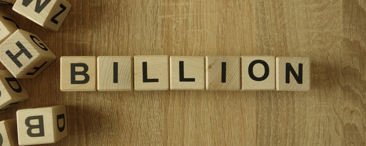 spelling the word “billion” using wooden letter blocks