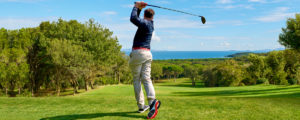 Golfer with golf club hitting the ball for the perfect shot