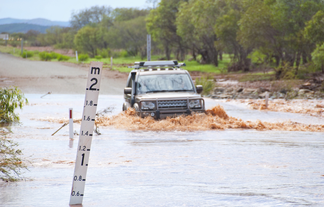 a vehicle driving on a flooded road