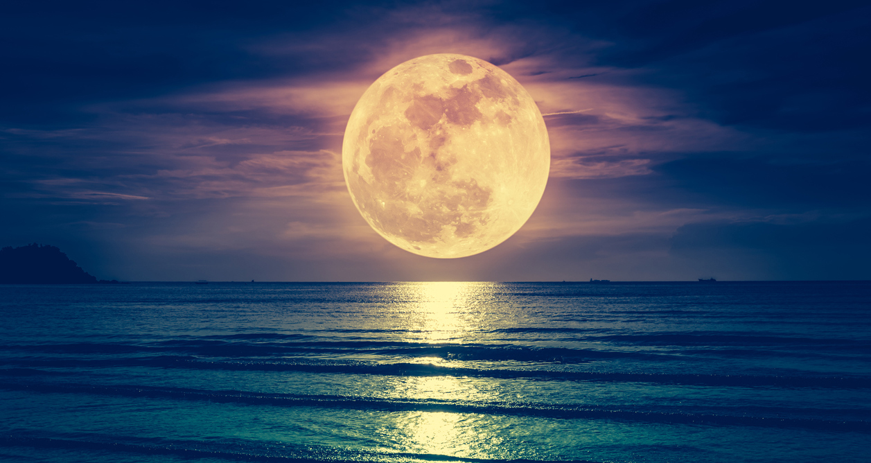 the moon above the sea