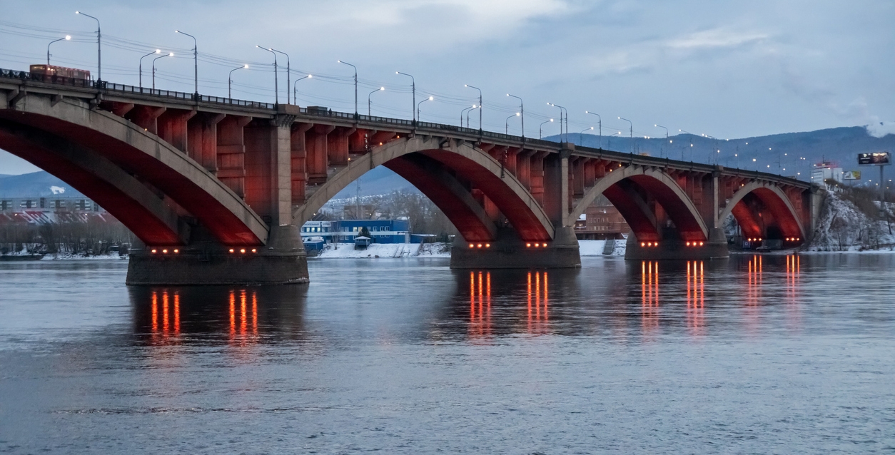Automobile Communal Bridge (1961) with night illumination across the Yenisei River in Russia