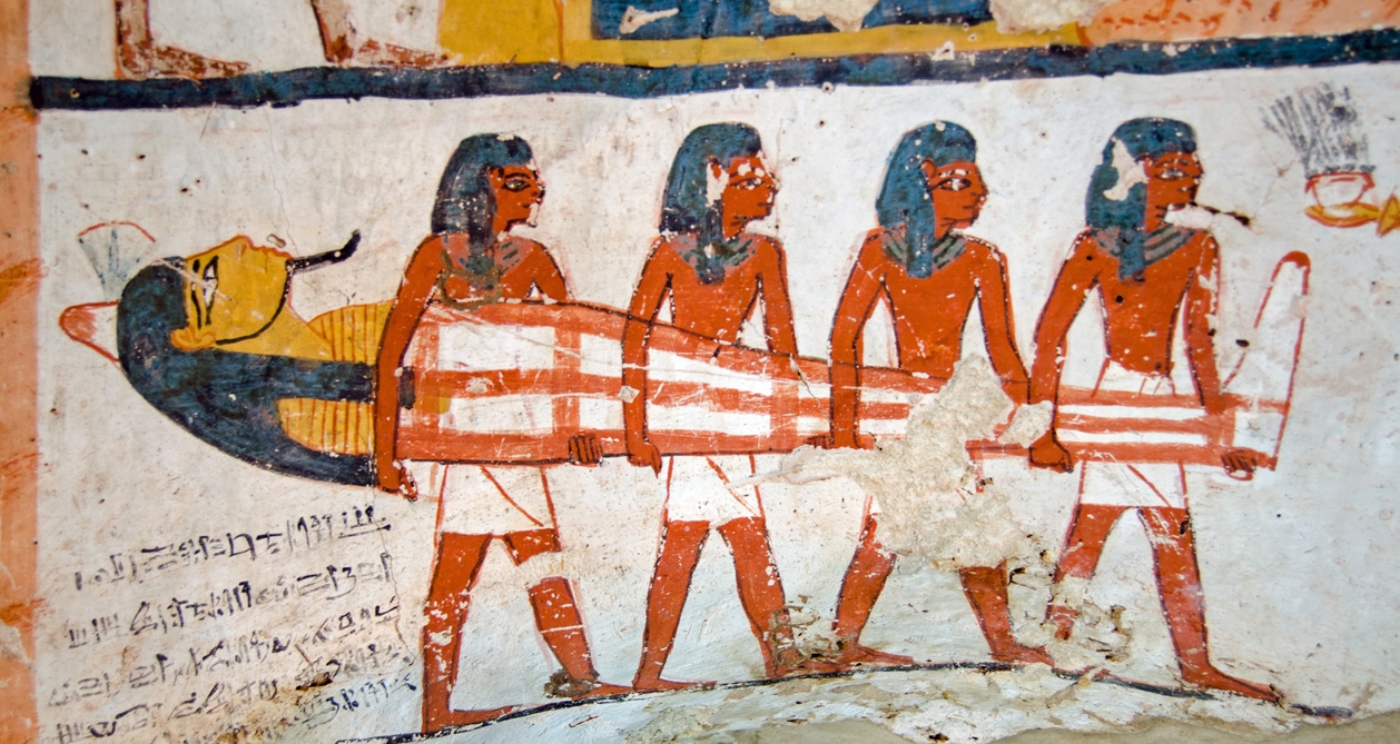 an art of four men carrying the tomb of Amenemhet