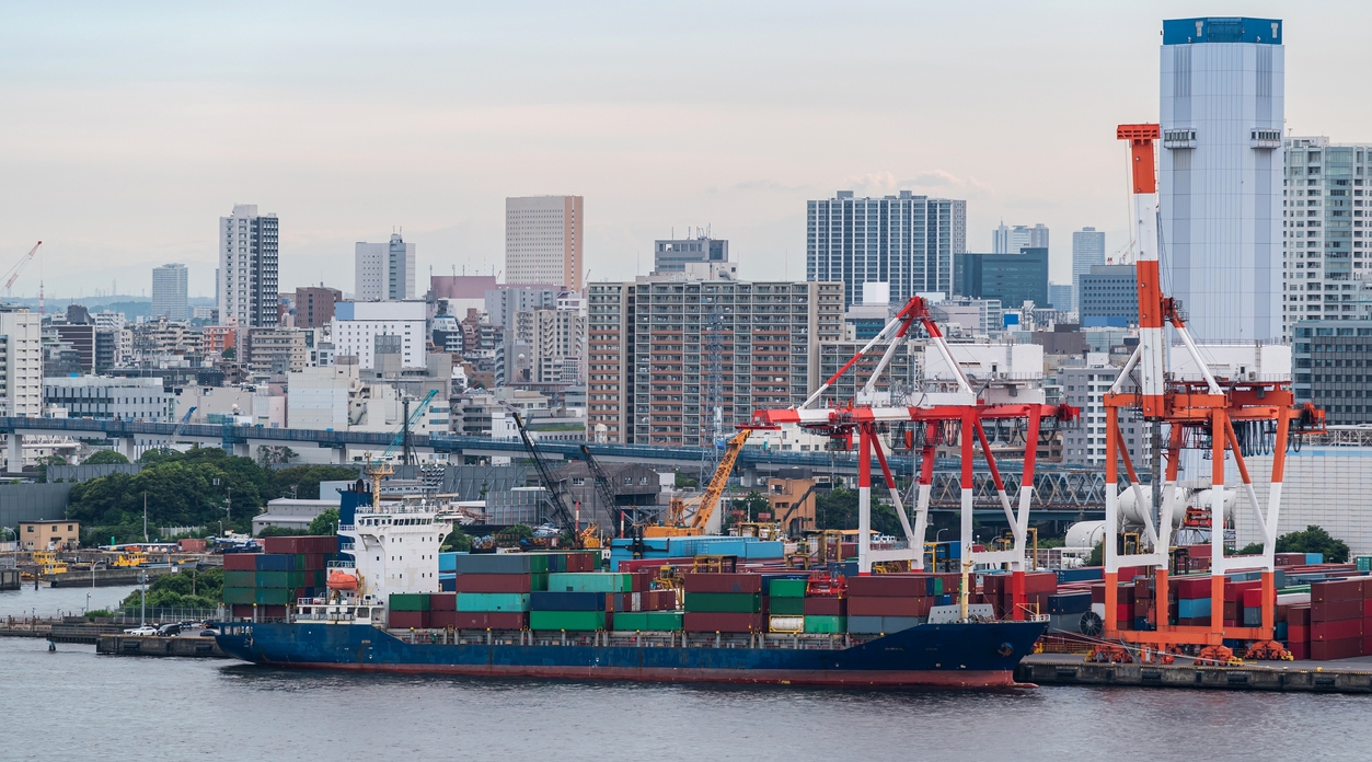 large cargo containers are stacked at the pier docks at Tokyo Bay Port in Tokyo Japan