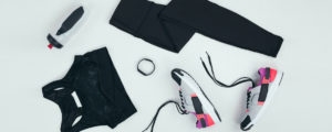 sportswear with sneakers, fitness tracker and sports bottle