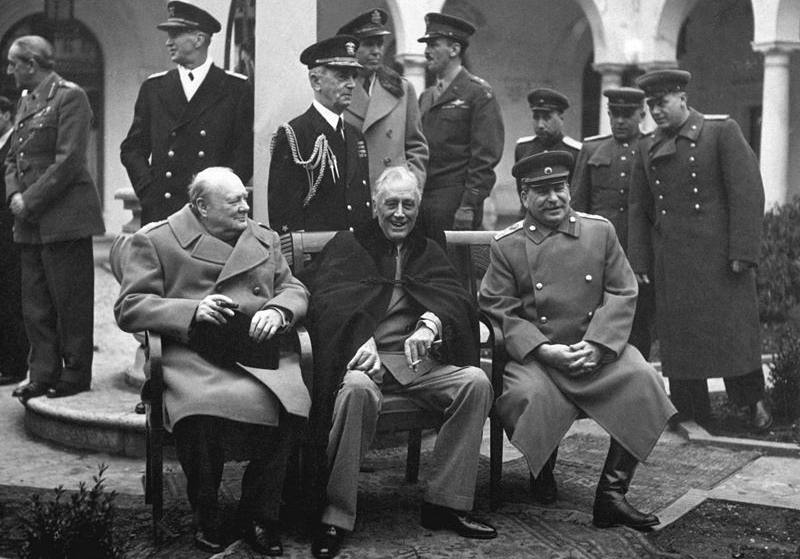 "Big Three:" Winston Churchill, Franklin D. Roosevelt, and Joseph Stalin at the Yalta Conference surrounded by other men