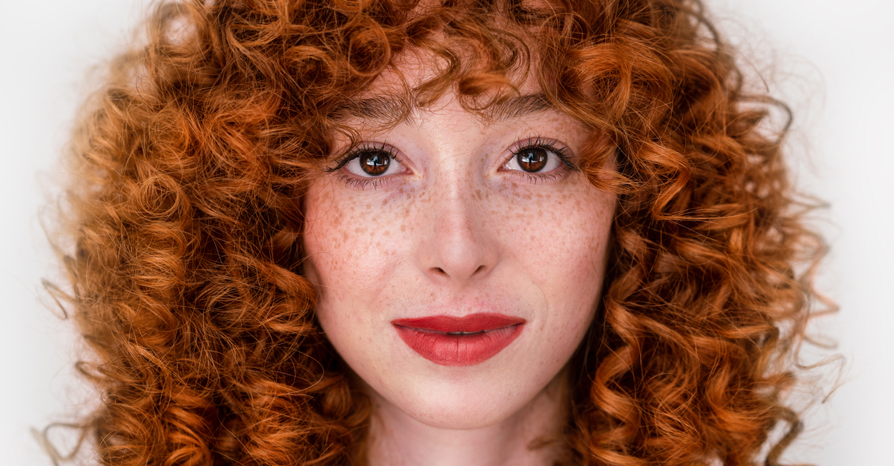 Face of a beautiful woman with red hair