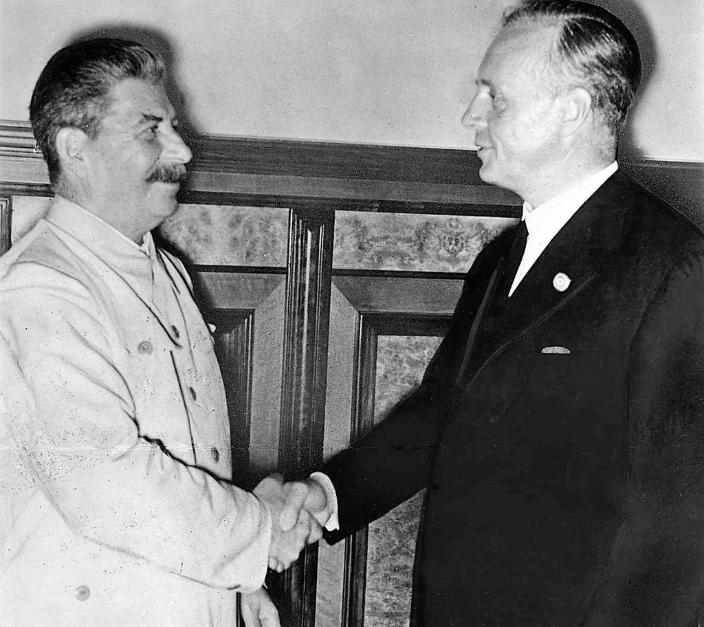 Stalin and Ribbentrop shaking hands after signing the non-aggression pact
