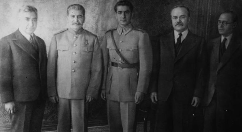 The Shah of Iran pictured to the right of Joseph Stalin with other men at the Tehran Conference