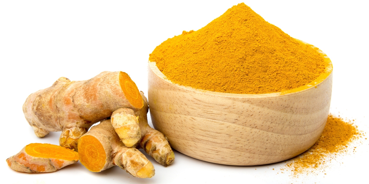 Turmeric powder in a wooden cup