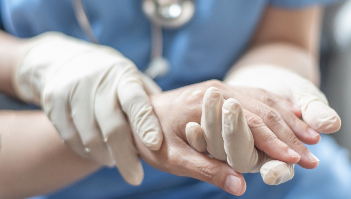 a doctor holding the hand of a patient