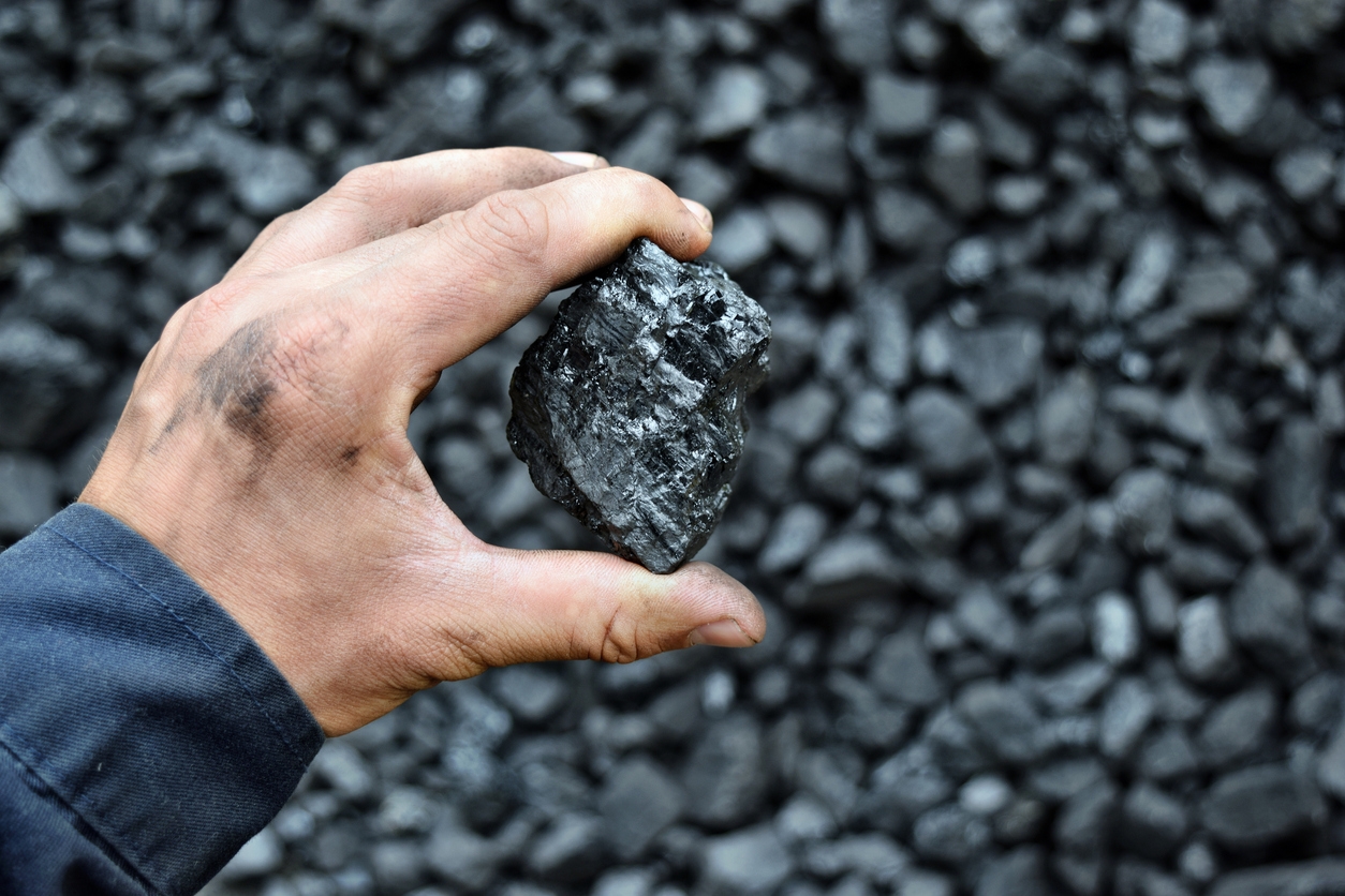 coal in the hand of a worker
