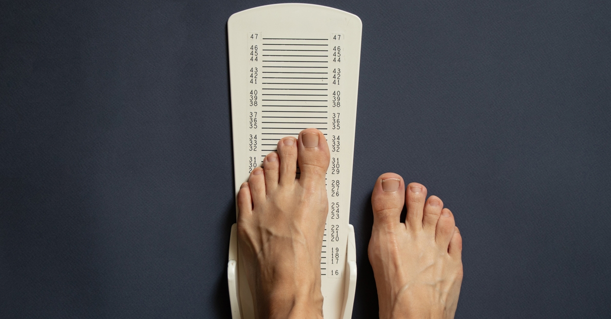 person measuring foot