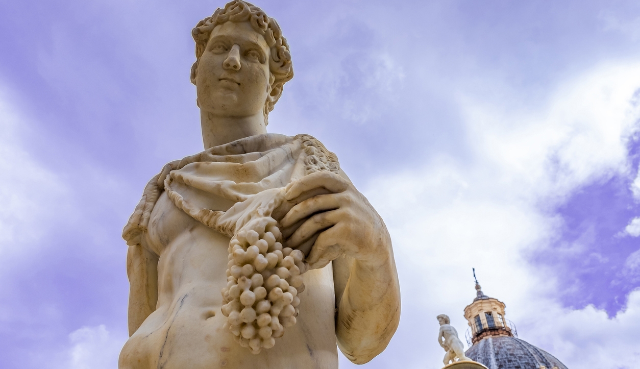 statue of Dionysus holding a bunch of grapes