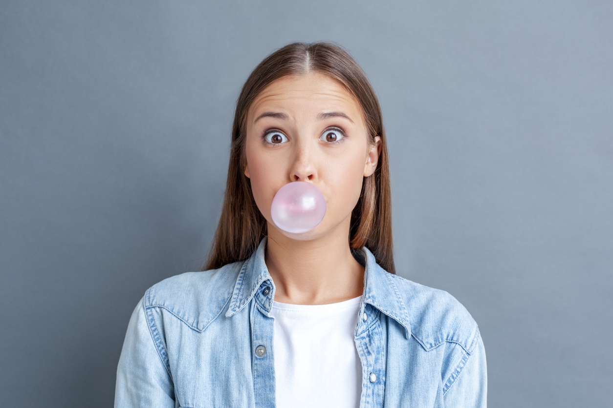 girl blowing chewing gum