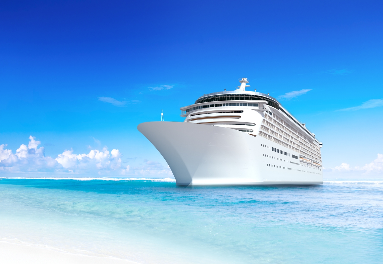 a large cruise ship by the beach