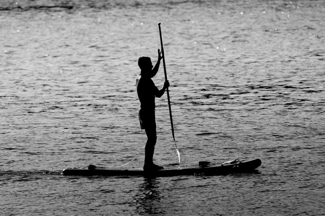a man paddleboarding